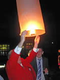Toastmaster Richard Palmer at a wedding reception launching chinese lanterns