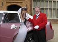 Toastmaster assisting bride from wedding car