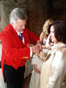 Essex toastmaster assisting wedding guests with button holes